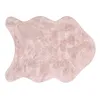 A fluffy, pink, irregularly shaped rug on a white background. Produktbild-Vorschau