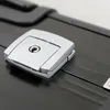 A close-up of a silver latch on a black aluminum briefcase. Náhled obrázku produktu