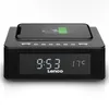 A black Lenco alarm clock with a smartphone placed on top, charging wirelessly. The clock displays the time and temperature. Produktbild-Vorschau