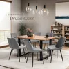 A dining room scene with a wooden table and chairs, set for a meal. Produktbild-Vorschau