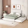 A white upholstered bed with a trundle pulled out, set in a bedroom with modern decor. Produktbild-Vorschau