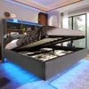 A modern bedroom with a grey upholstered bed frame featuring built-in storage and LED lighting. Produktbild-Vorschau