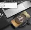 A smartphone is wirelessly charging on a charging pad next to a laptop and a notebook. Produktbild-Vorschau