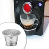A coffee machine brewing espresso into a glass cup, with a reusable coffee capsule shown in the foreground. Náhled obrázku produktu