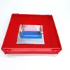A red baking dish and frame with a printed insert showing a blue tray and instructions. Produktbild-Vorschau