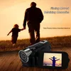 A father and son walking in a field at sunset, with a digital camera in the foreground. Produktbild-Vorschau