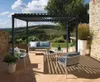 A patio area with a pergola, outdoor furniture, and a scenic landscape in the background.