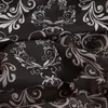 A close-up view of a dark fabric with a white and gray floral pattern. Produktbild-Vorschau