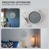 Collage of three images showing a gray wall clock with a white frame in different room settings. Náhled obrázku produktu