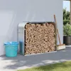 A firewood storage rack filled with wood, placed against a white wall outdoors, with a bucket and broom nearby. Náhľad obrázku produktu