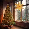A decorated Christmas tree with presents underneath, next to a window with a large star decoration. Anteprima dell’immagine prodotto