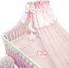 A baby crib with bedding and a canopy. Náhled obrázku produktu