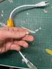 A hand holding a small electrical component in front of a cutting mat with a power cord and adapter visible. Podgląd zdjęcia produktu