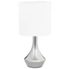 A table lamp with a silver base and a white shade, presented on a white background. Náhľad obrázku produktu