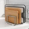 A cutting board organizer stand holding multiple cutting boards on a kitchen counter. Produktbild-Vorschau