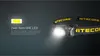 A Nitecore HA11 headlamp is shown with its light on, against a dark background. Text describes its LED technology. Podgląd zdjęcia produktu
