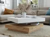 A modern living room scene featuring a white and wood-tone coffee table. Produktbild-Vorschau