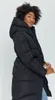 A woman wearing a black puffer coat. Produktbild-Vorschau