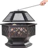 A hand is holding a poker to lift the lid of a fire pit. Anteprima dell’immagine prodotto