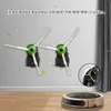 Two side brushes for an iRobot Roomba vacuum cleaner are shown mounted on a wall, with a close-up inset of one brush and a Roomba vacuum cleaner on the floor. Produktbild-Vorschau