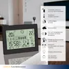 A black digital weather station is displayed on a table, with a list of its features on the right side of the image. Produktbild-Vorschau