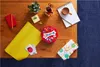 A collection of gift-wrapping items and a box of chocolates are arranged on a wooden table. Produktbild-Vorschau