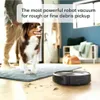 A robot vacuum cleaner is shown on a wooden floor with debris, near a dog and a person. Náhled obrázku produktu