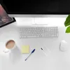 A desk with a computer, keyboard, mouse, coffee cup, pen, sticky note, and a phone case. Produktbild-Vorschau