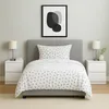 A bedroom scene with a bed, nightstands, and a picture frame. Produktbild-Vorschau