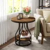 A round side table with a wooden top and black metal frame, placed next to a sofa in a living room setting. Produktbild-Vorschau