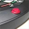 A close-up of a red button on a black dartboard with some numbers visible. Produktbild-Vorschau