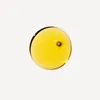 A single drop of golden oil on a white background. Voir les images du produit