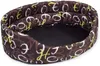 An oval-shaped pet bed with a brown fabric cover featuring a pattern of white and yellow letters. Produktbild-Vorschau