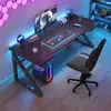 A modern gaming desk setup with a computer, monitor, keyboard, and accessories, illuminated by colorful LED lighting. Podgląd zdjęcia produktu