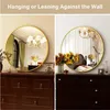 A collage showing a round gold mirror displayed in two different interior settings, one on a dresser and the other leaning against a wall. Produktbild-Vorschau