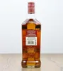 A bottle of Grant's The Family Reserve Blended Scotch Whisky is shown from the back, standing on a wooden surface against a white background. Produktbild-Vorschau