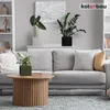 A living room scene with a sofa, coffee table, and plants. Produktbild-Vorschau