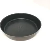 A close-up, high-angle shot of a round baking pan with a textured interior. Voir les images du produit