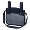 A close-up view of a navy blue and gray doll stroller bag with two straps on top and a shoulder strap. Produktbild-Vorschau