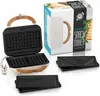 A 3-in-1 snack maker with interchangeable plates, shown open with waffle plates inserted, and with sandwich and grill plates displayed separately next to its packaging. Produktbild-Vorschau