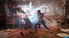 Two people fighting in a room with traditional Asian decor. Anteprima dell’immagine prodotto