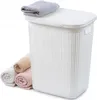 A white laundry basket with a lid, with several rolled towels next to it and one folded towel on top. Voir les images du produit