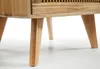 Close-up of the wooden legs and lower part of a cabinet with a woven detail. Podgląd zdjęcia produktu