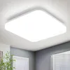 A white square ceiling light fixture is mounted on a textured white ceiling, with parts of a room visible in the background. Anteprima dell’immagine prodotto