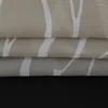 A close-up view of folded fabric with a white abstract pattern on a beige and gray background. Produktbild-Vorschau