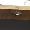 A close-up view of a wooden table with a metal latch connecting two sections. Náhled obrázku produktu