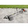 A gas-powered string trimmer with a blade attachment rests on a paved patio, with a grassy area in the background. Produktbild-Vorschau
