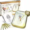 A Harry Potter themed drawing tablet and coloring pencils are displayed with the product packaging in the background. Produktbild-Vorschau