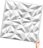A white 3D wall panel with a geometric design is held by a person's hand. Podgląd zdjęcia produktu