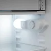 Close-up view of the interior of a refrigerator, showing the temperature control dial and a light. Produktbild-Vorschau